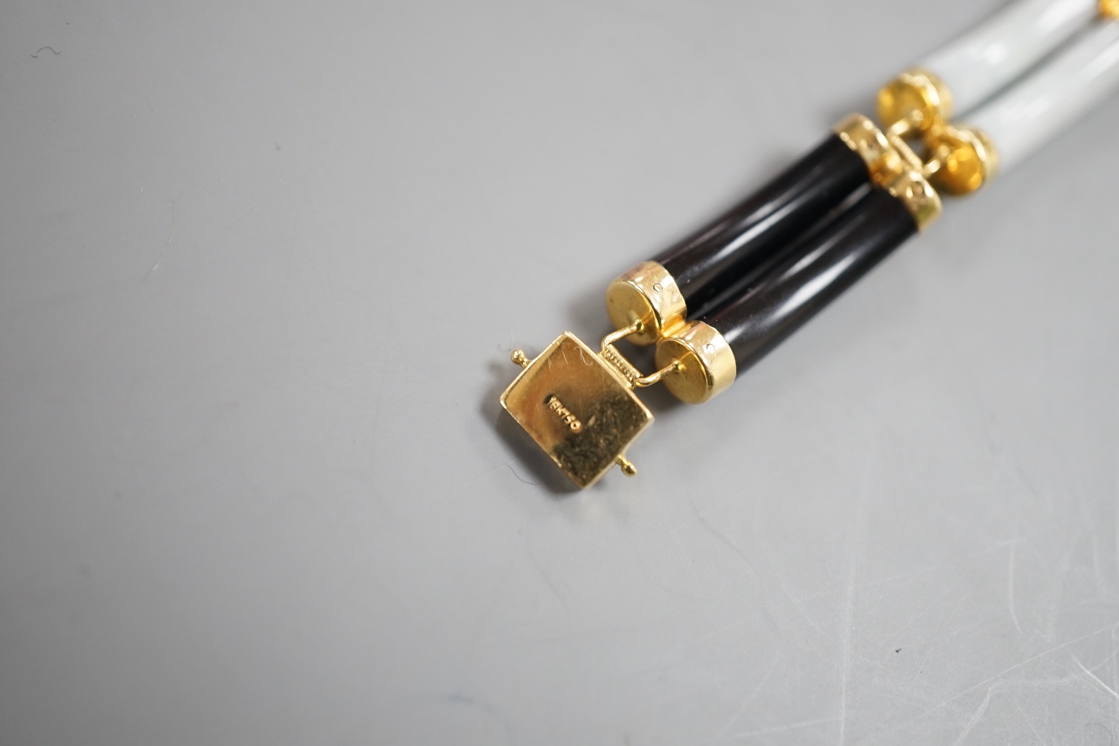 A Chinese 18k, black onyx and multi coloured jade set bracelet, 17.75cm, gross weight 20 grams.